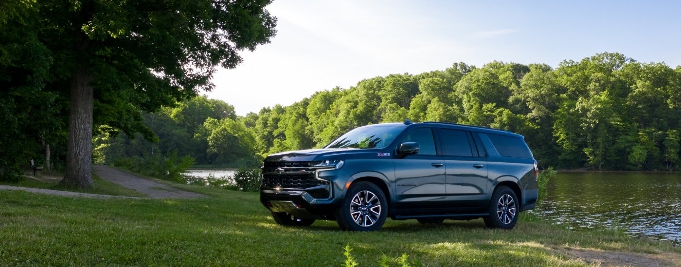 A grey 2025 Chevy Suburban from the side.