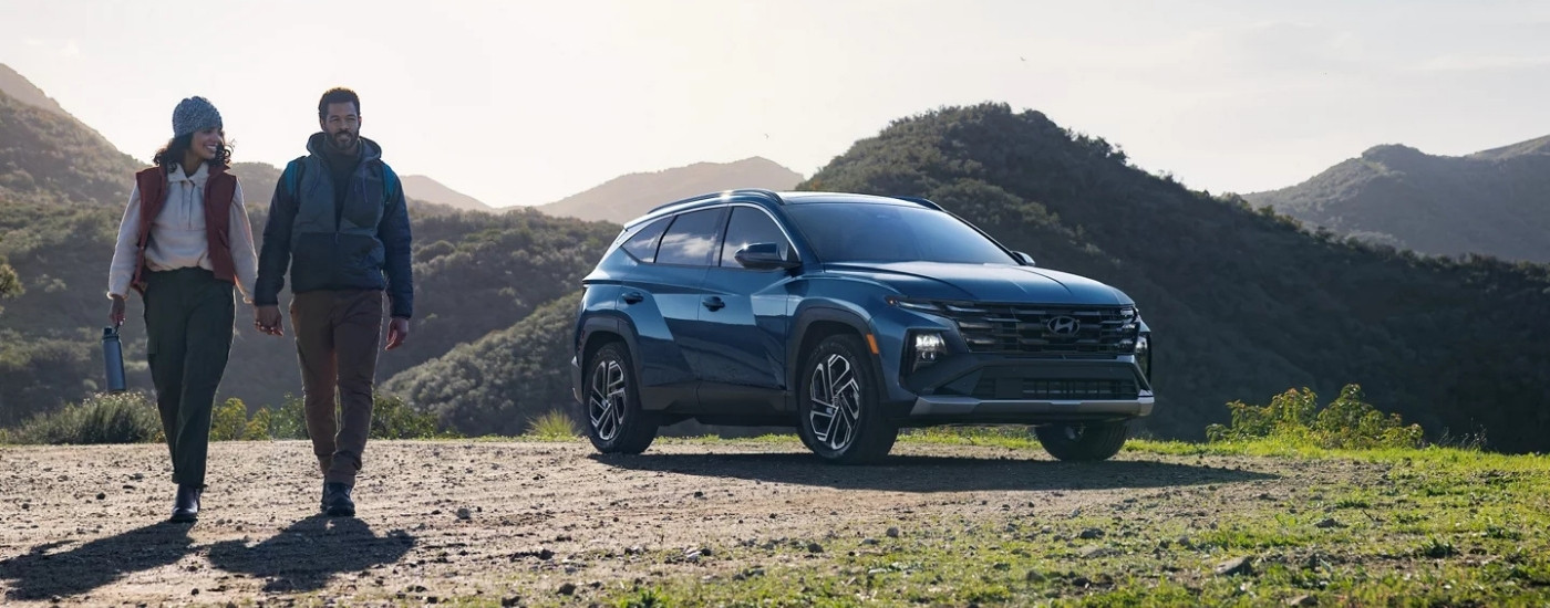 A blue 2025 Hyundai Tucson for sale in Houston parked near mountains.