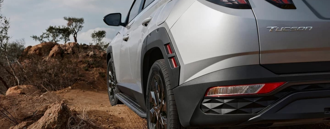 A silver 2023 Hyundai Tucson XRT parked off-road.