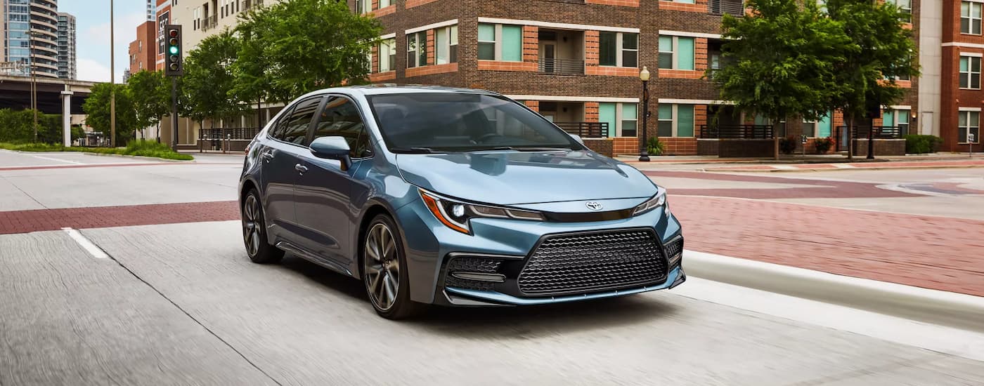 Blue 2022 Toyota Corolla driving through a city