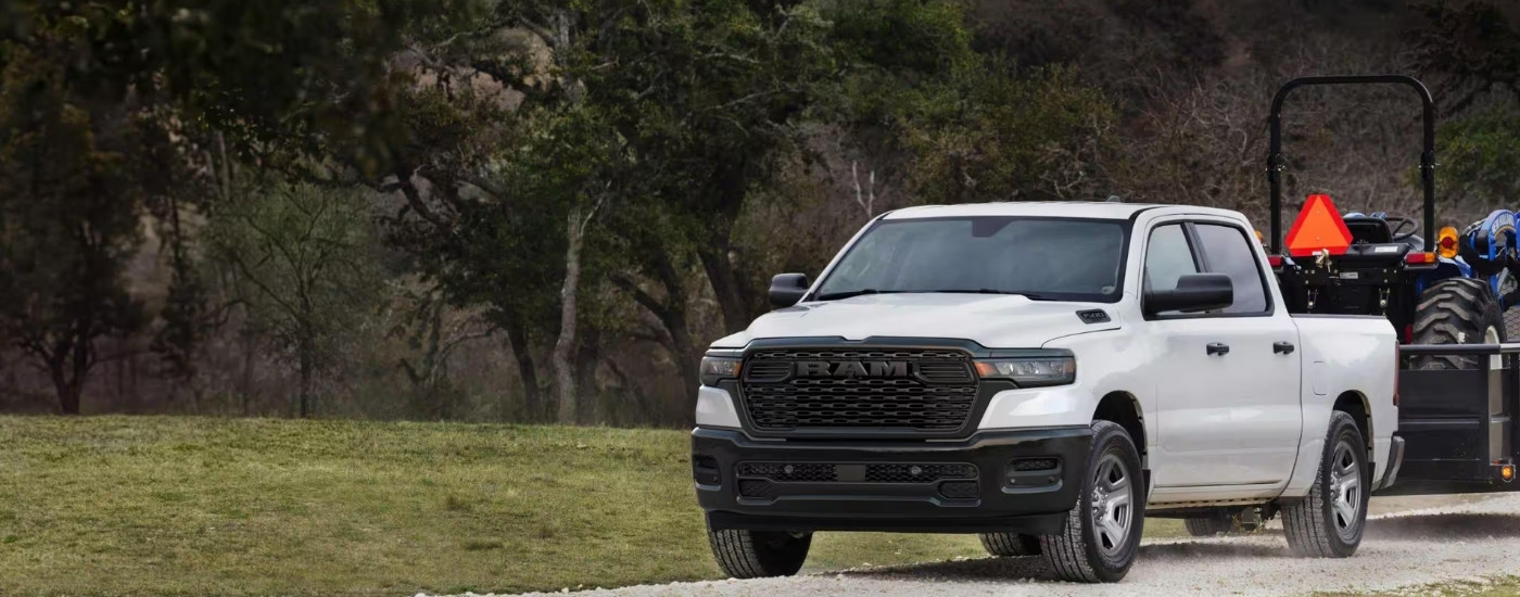 A white 2025 Ram 1500 from the front after leaving a Ram dealer near Omaha.