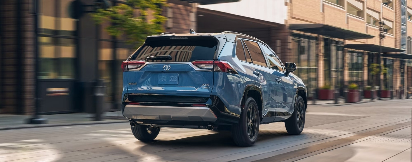 A blue 2025 Toyota RAV4 for sale near New Braunfels from the rear.