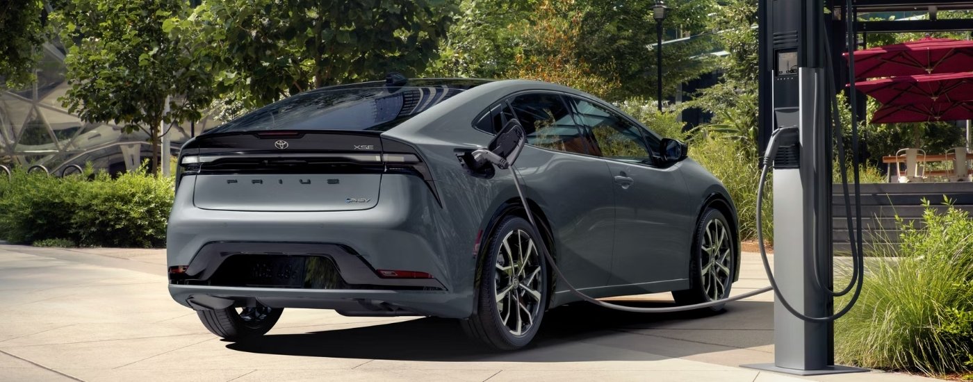A grey 2023 Toyota Prius from the rear at an angle.