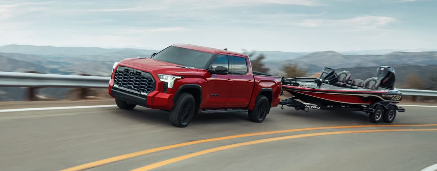 Red 2024 Toyota Tundra towing a fishing boat