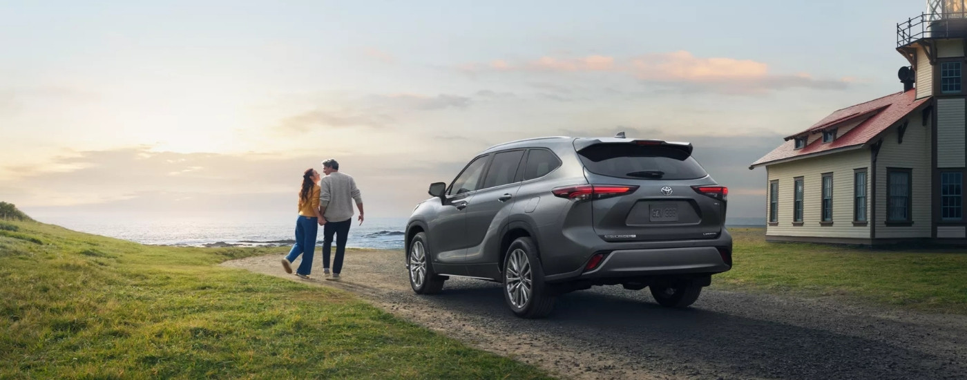 A grey 2025 Toyota Highlander from the rear at an angle.