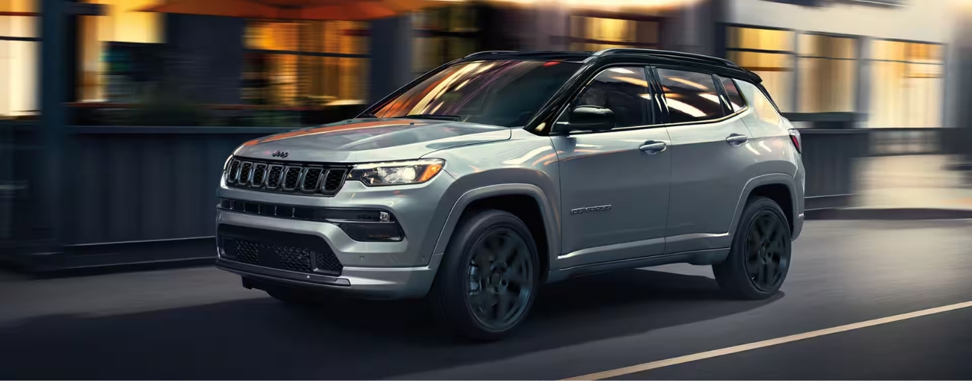 A silver 2025 Jeep Compass from the side.