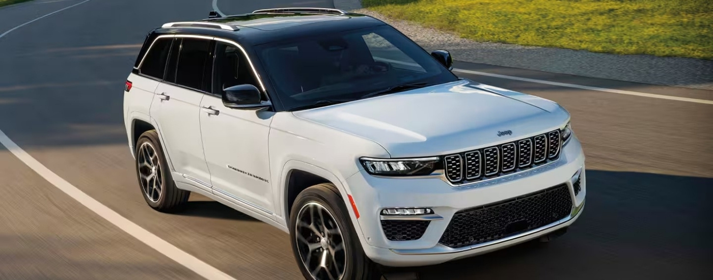 A white 2025 Jeep Grand Cherokee from the front.
