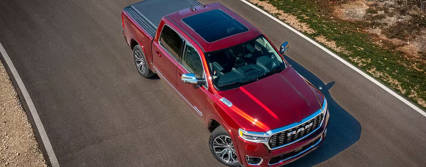 A red 2025 Ram 1500 Tungsten parked after leaving a Ram dealer in Houston.