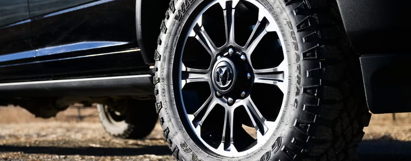 Tire and rim on a black 2025 Ram 2500 parked on dirt