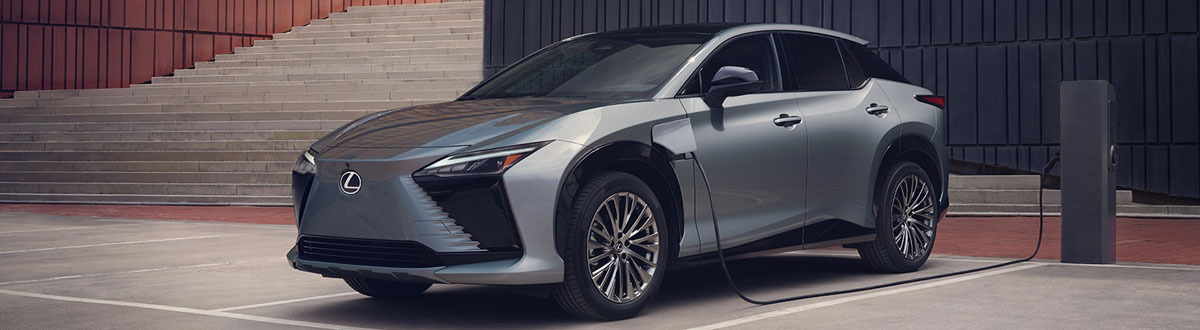 2025 Lexus RZ Electric SUV Charging in Parking Lot