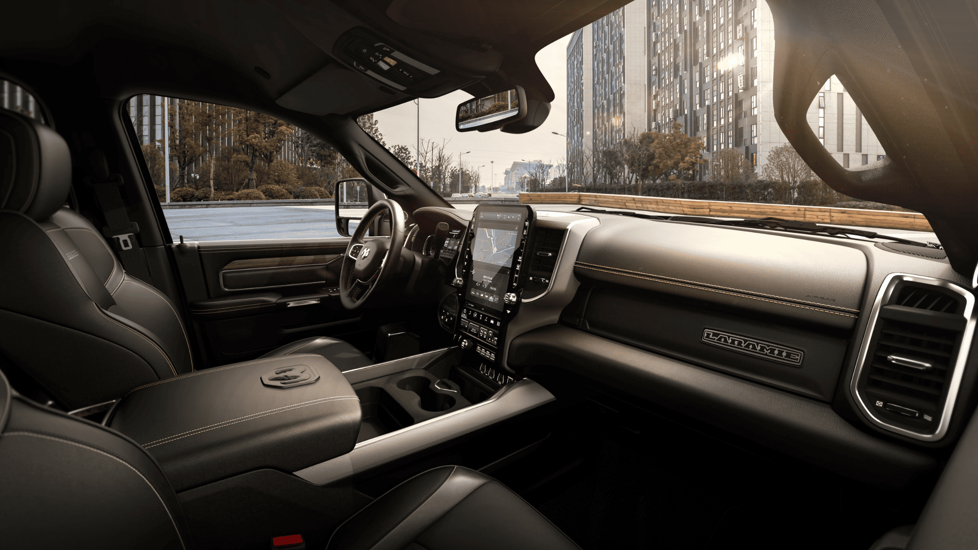 Premium black leather interior of the 2025 Ram 2500 with Laramie badging and large vertical touchscreen.