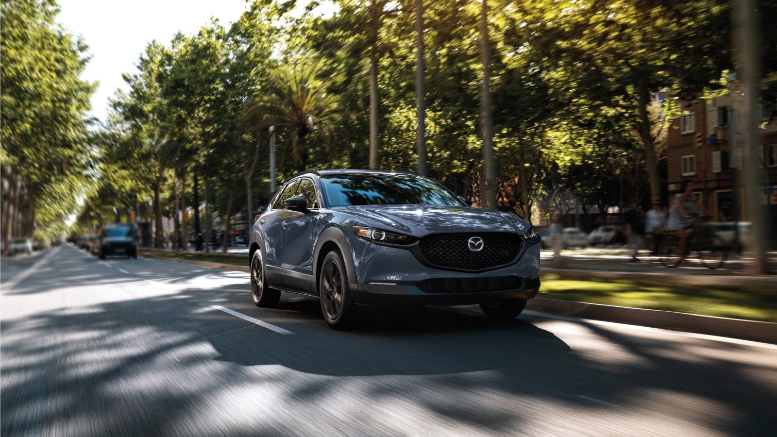blue mazda cx-30 driving
