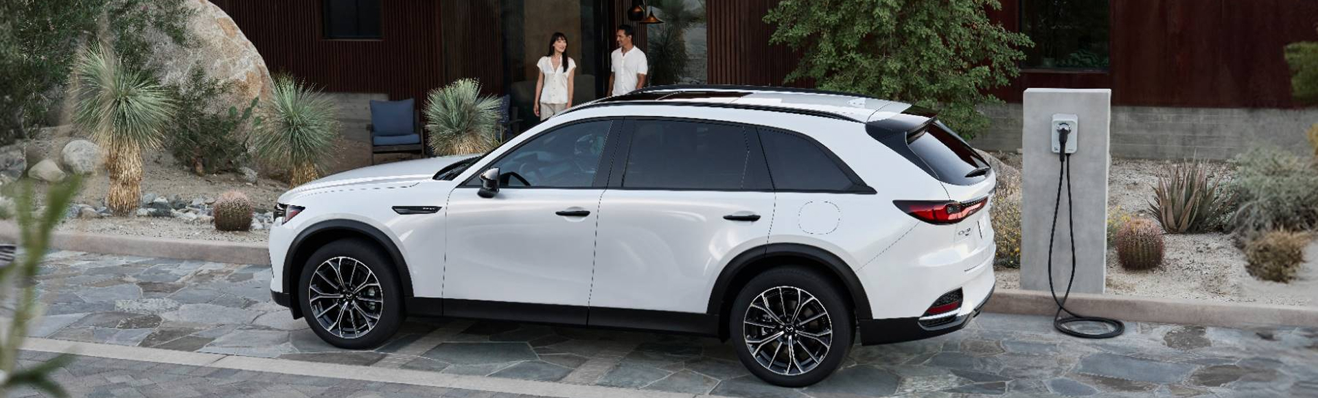 Mazda parked by electric charger