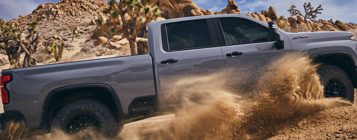 Grey 2025 Chevy Silverado 2500HD ZR2 off-roading through sand