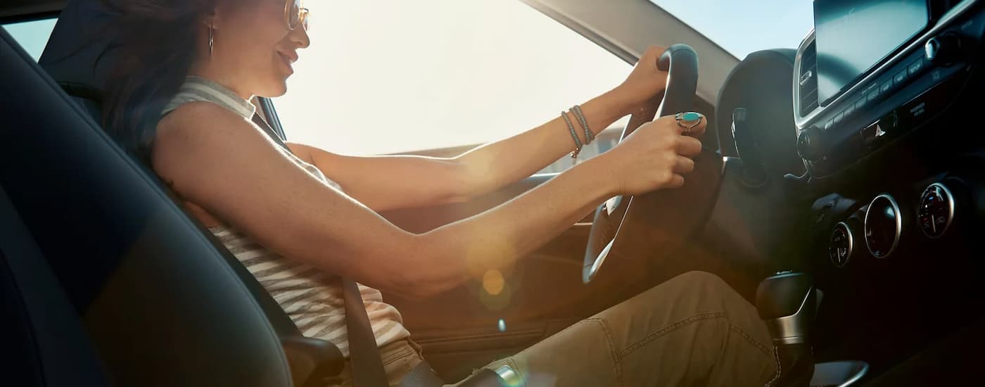 Woman test driving in a used 2025 Hyundai Venue for sale near Bellaire