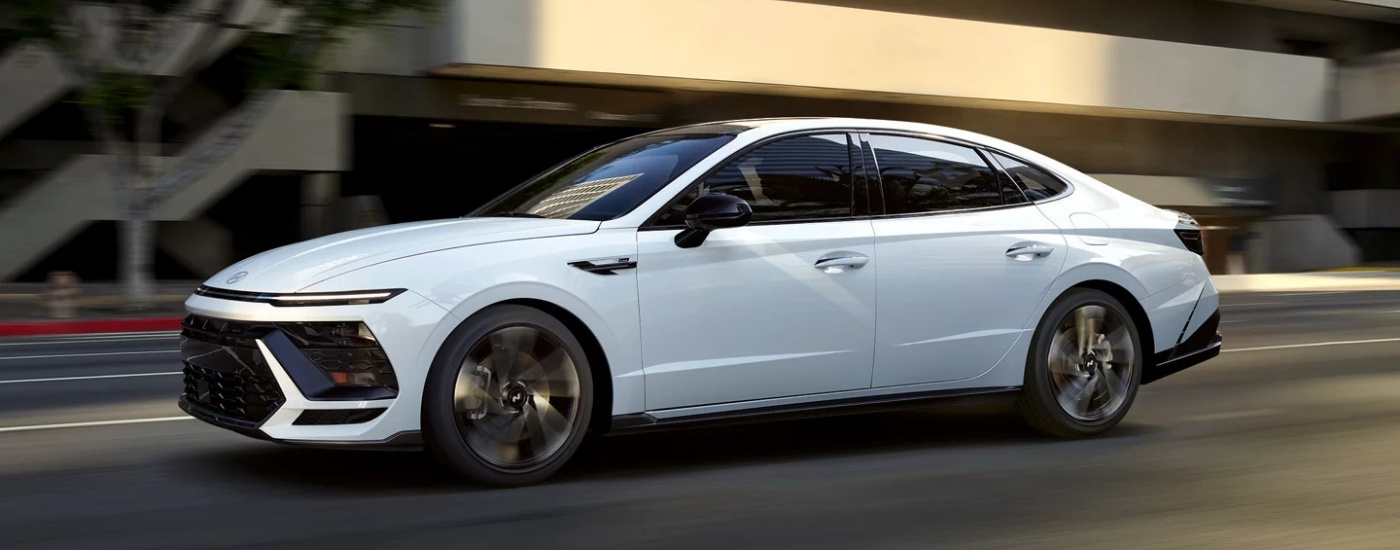 A white 2025 Hyundai Sonata from the side after leaving a Hyundai dealer near Meyerland.