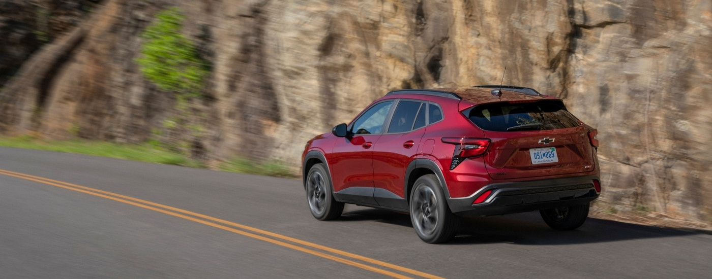 A red 2025 Chevy Trax from the rear at an angle.