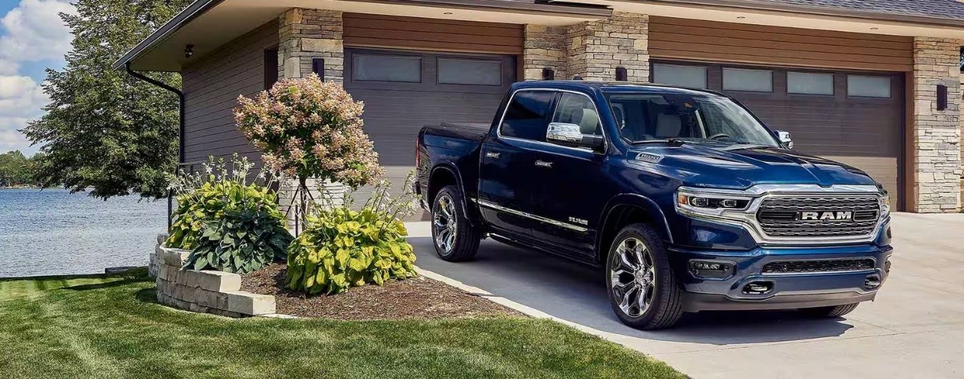 A blue 2023 Ram 1500 Limited Elite Edition parked on a driveway.