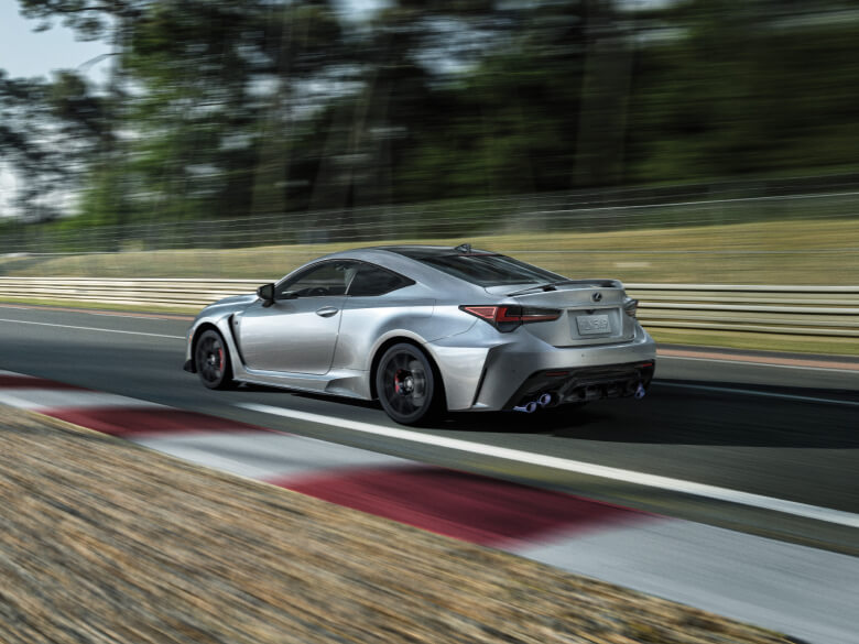 Silver Lexus sports car driving down a track