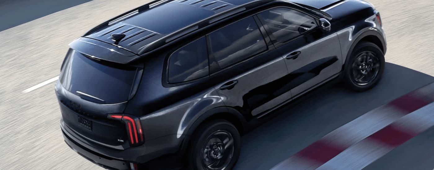 Black 2025 Kia Telluride driving on a track