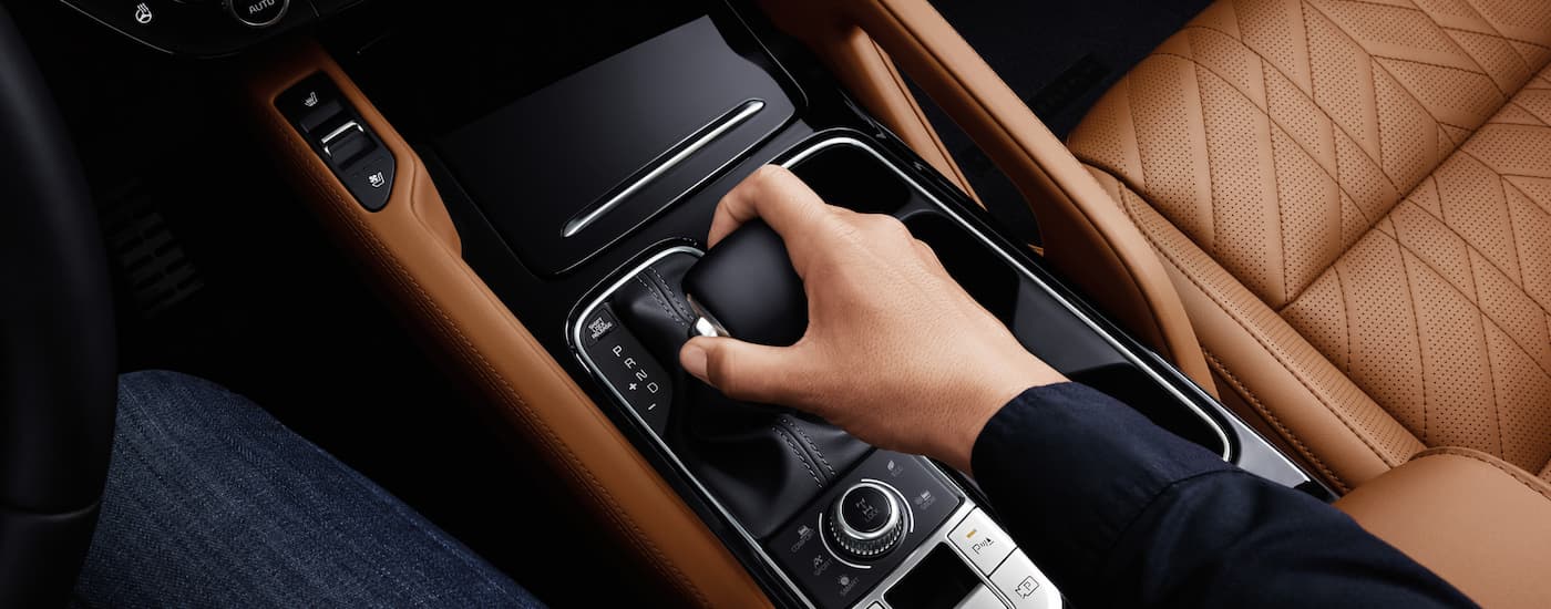 Person using the shifter in the center console of a 2025 Kia Telluride for sale near Lincoln