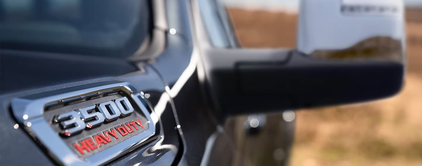 Close up of the hood badge on a black 2025 Ram 3500