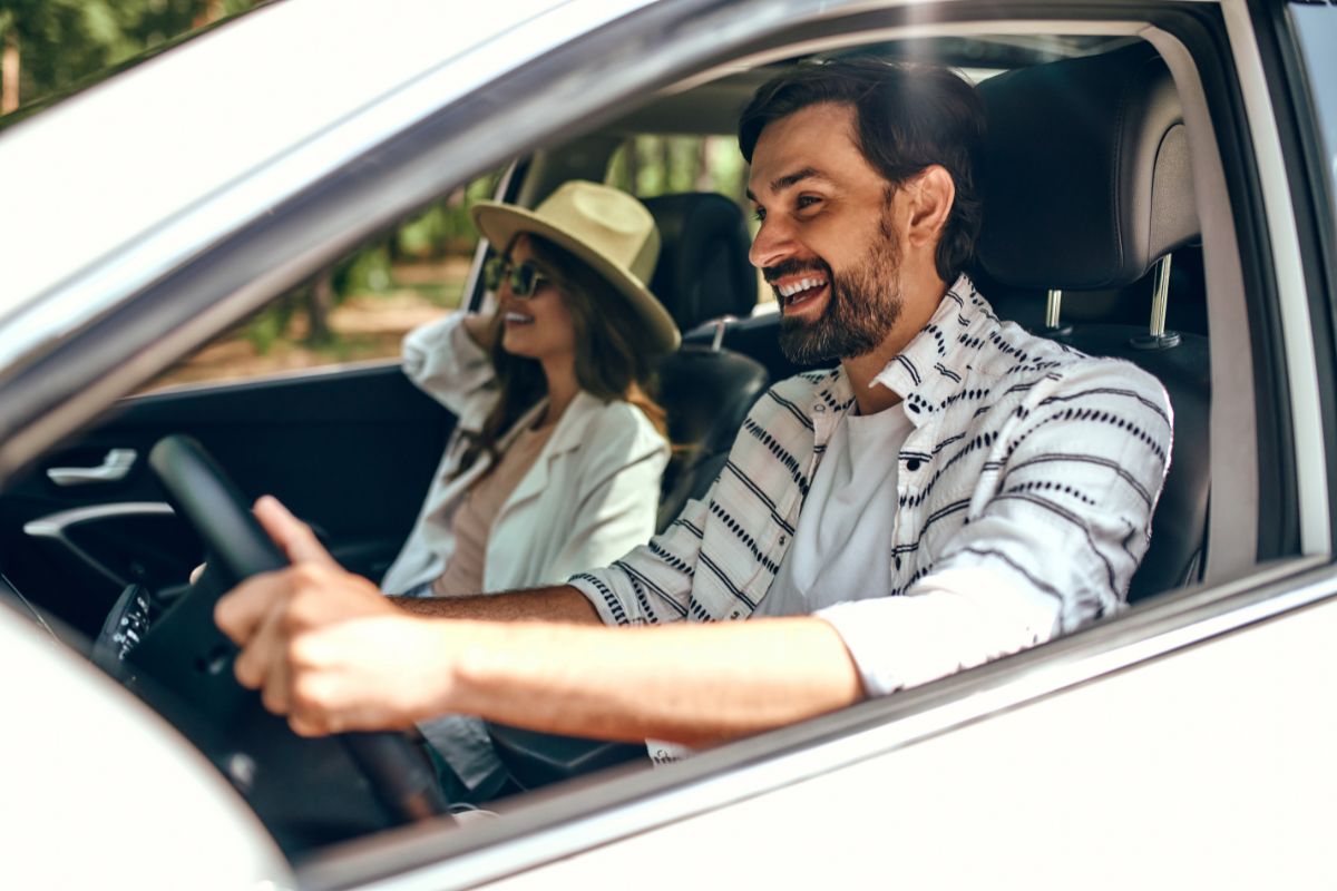 Smiling couple driving their new Honda SUV