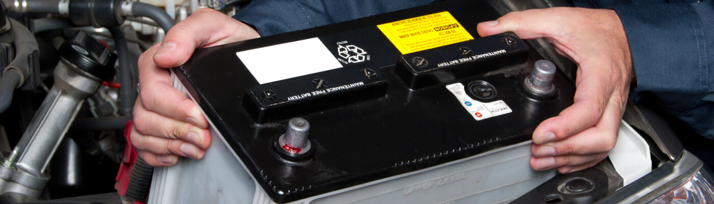 Auto Mechanic Replacing Car Battery