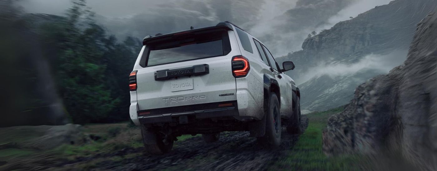 White 2025 Toyota 4Runner off-roading on a muddy trail