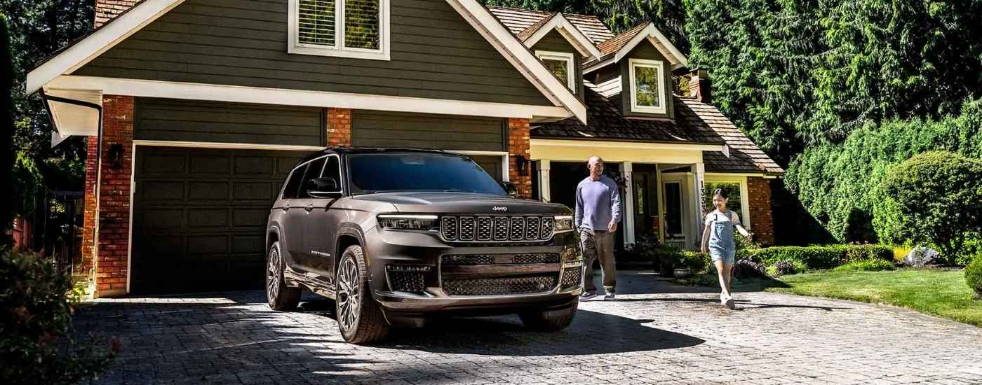 Grey 2025 2025 Jeep Grand Cherokee parked in a driveway