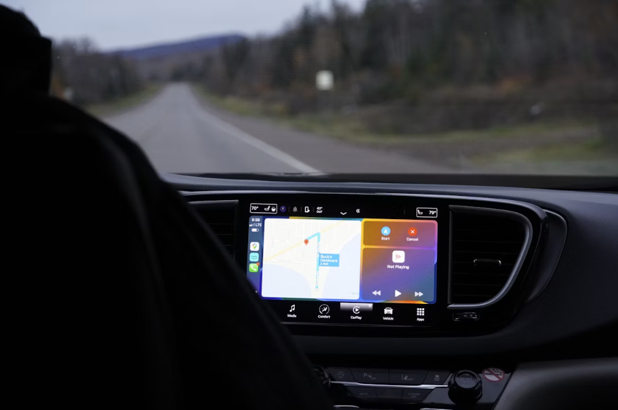 a man driving a car with a gps device in his hand
