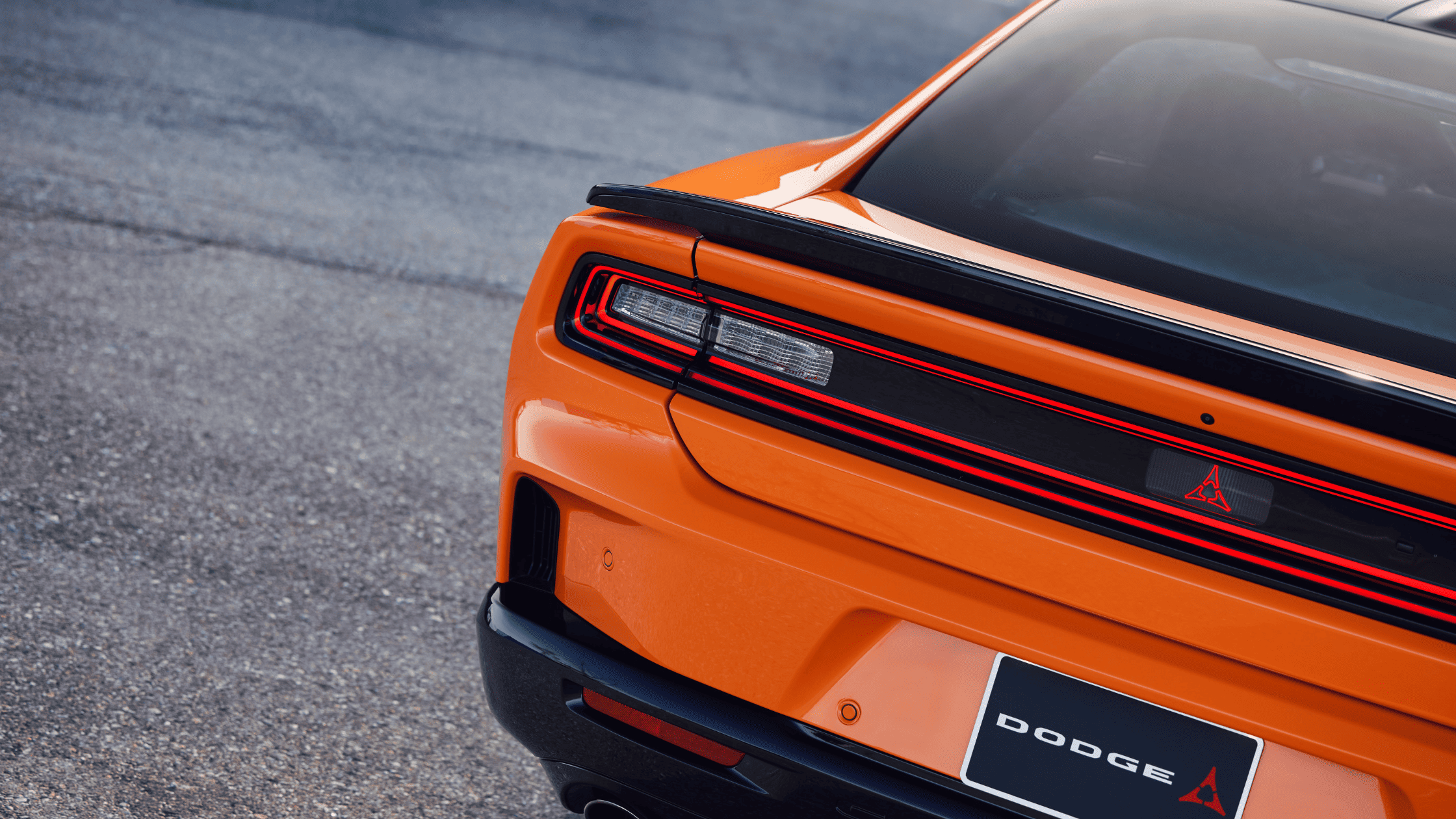 2026 Dodge Charger Daytona rear view showcasing LED taillights and black spoiler detail.