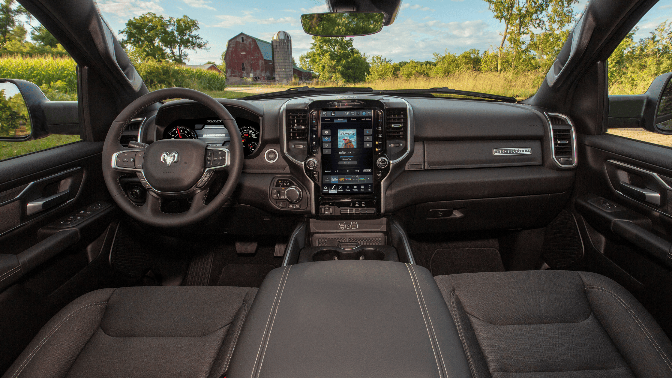 2026 Ram 1500 interior with digital display, leather steering wheel, and center console.