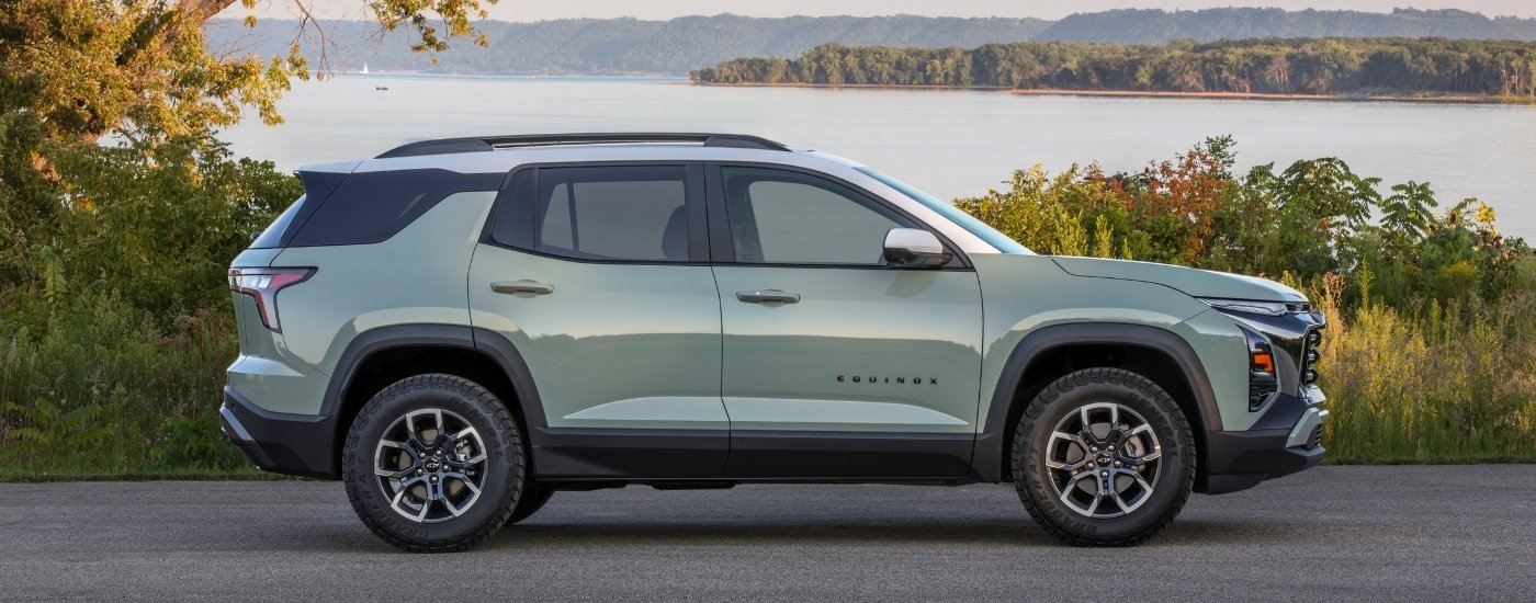 A green 2025 Chevy Equinox for sale near Council Bluffs from the side.