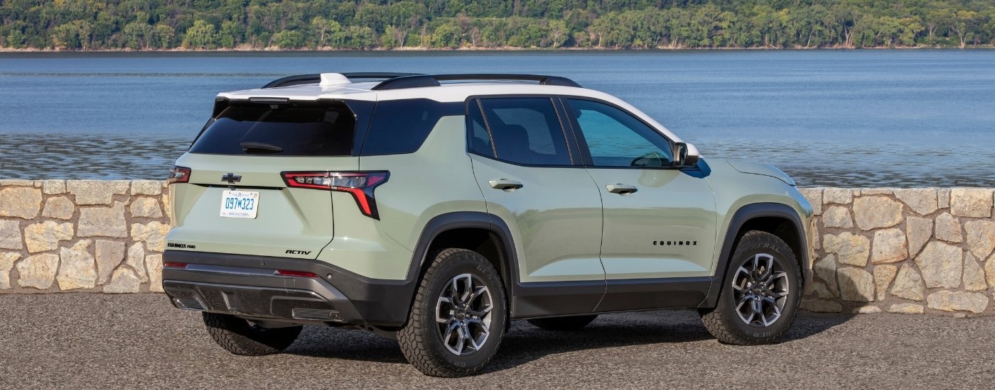 A green 2025 Chevy Equinox from the rear at an angle.