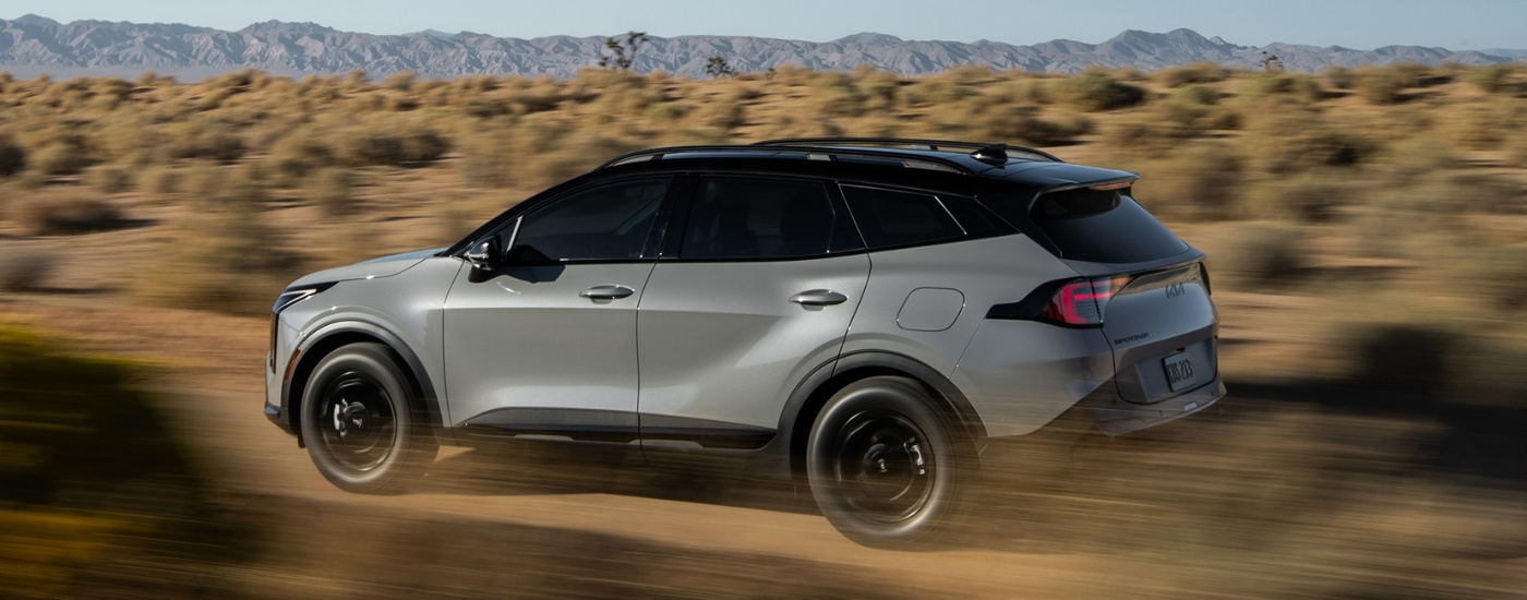 A grey 2026 Kia Sportage for sale near Bellevue from the side.