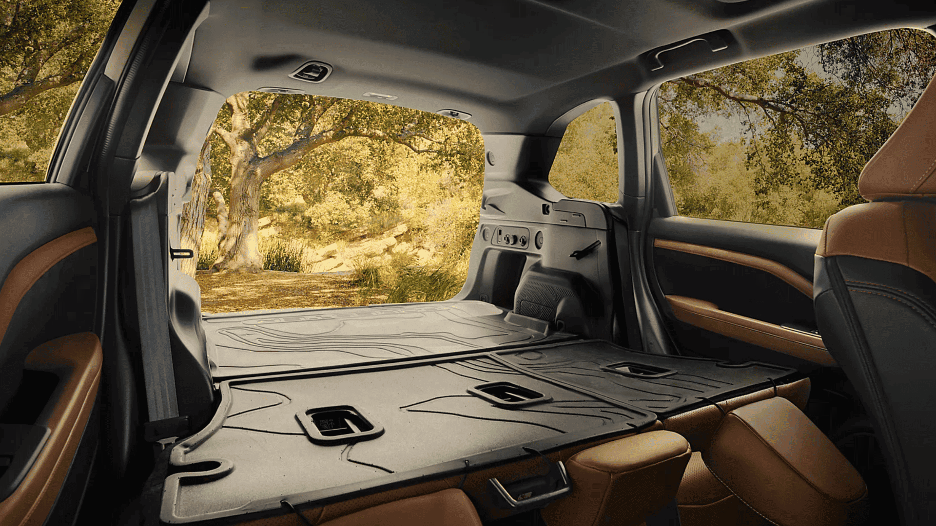 2025 Subaru Forester rear cargo area with folded seats, showing spacious cabin and durable materials.