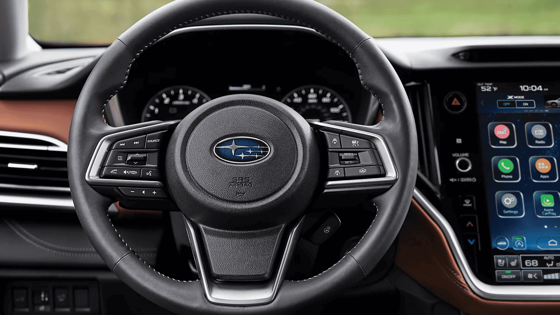 2025 Subaru Outback steering wheel and center screen featuring multimedia apps and navigation tools.