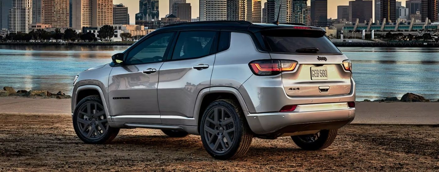 A silver 2025 Jeep Compass from the side after leaving a Jeep dealer near Tomball.