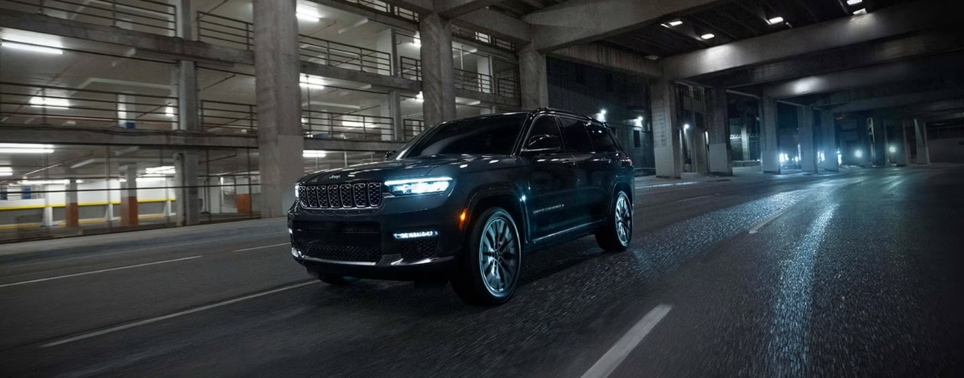 A black 2025 Jeep Grand Cherokee from the front at an angle after leaving a Jeep dealer near Hempstead.