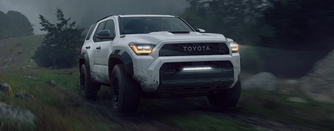 A white 2025 Toyota 4Runner for sale near San Antonio driving through the rain.