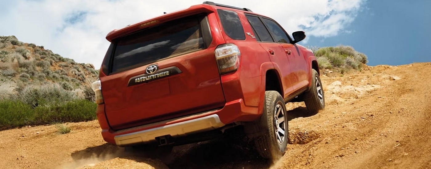 Red 2023 Toyota 4Runner TRD Off Road driving up a hill
