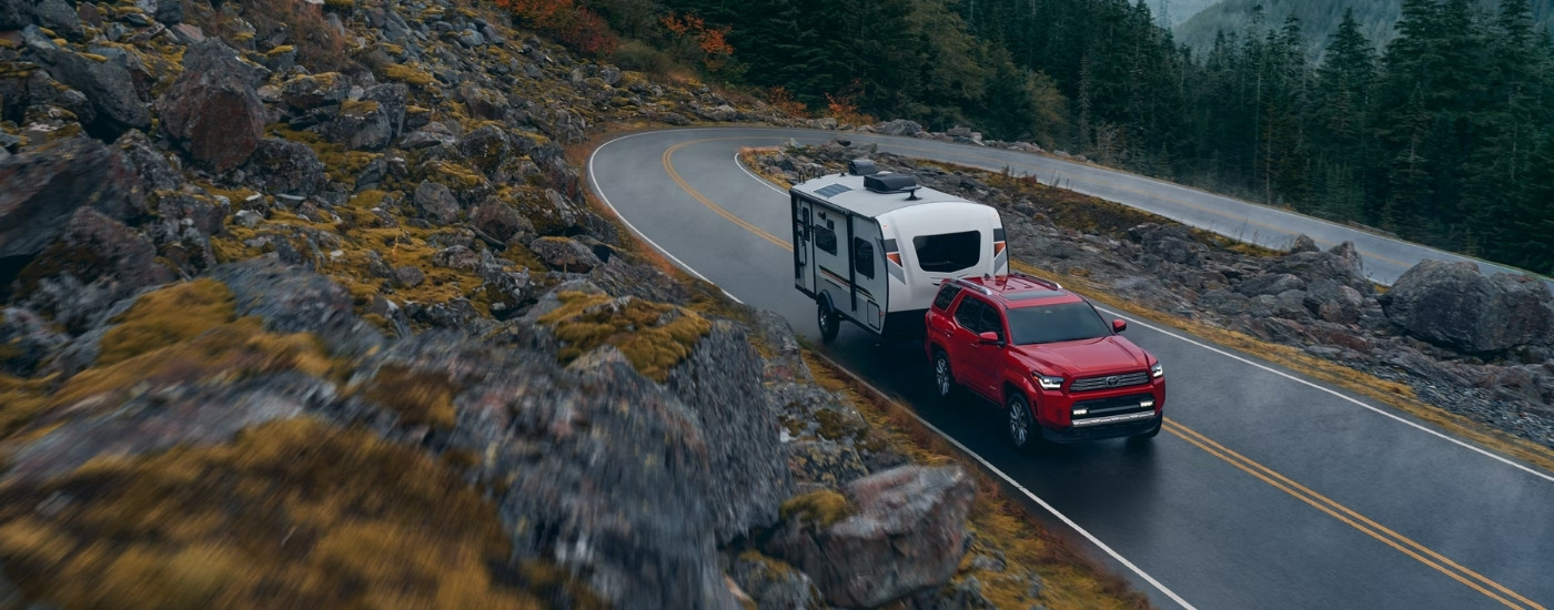 Red 2025 Toyota 4Runner for sale near Seguin towing a trailer.