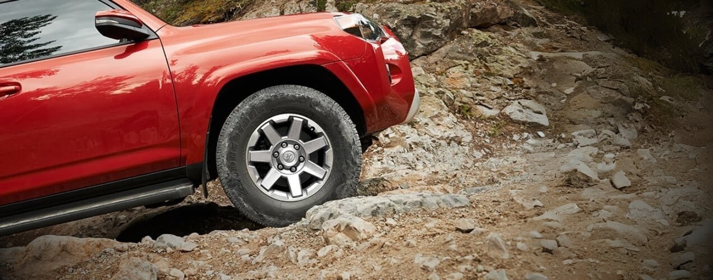 Close-up of a wheel on a red 2018 Toyota 4Runner off-roading