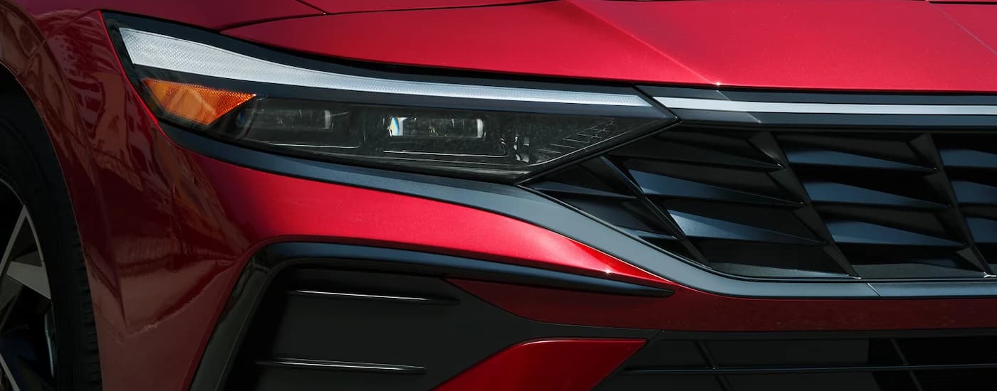Headlight and grille on a red 2025 Hyundai Elantra for sale near Manvel