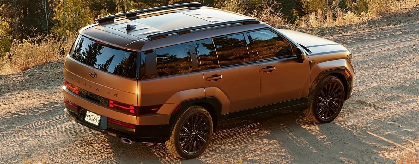 Tan 2025 Hyundai Santa Fe parked on a dirt road