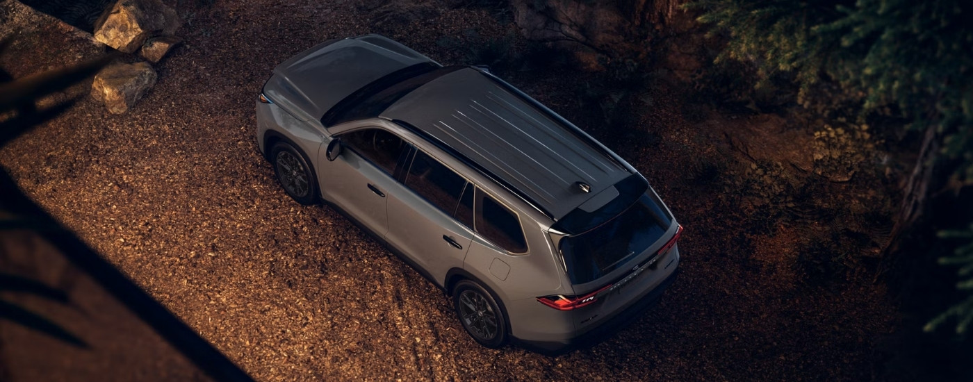 Grey 2025 Toyota Grand Highlander Hybrid Nightshade on a gravel lot