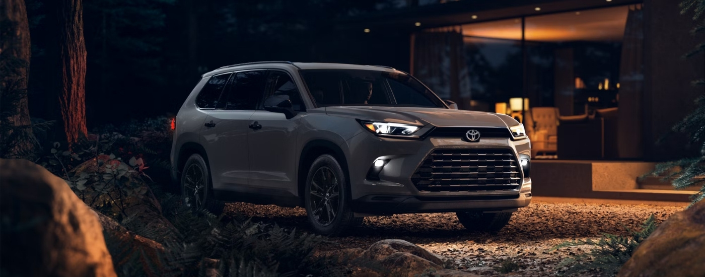 Grey 2025 Toyota Grand Highlander Hybrid Nightshade parked at night