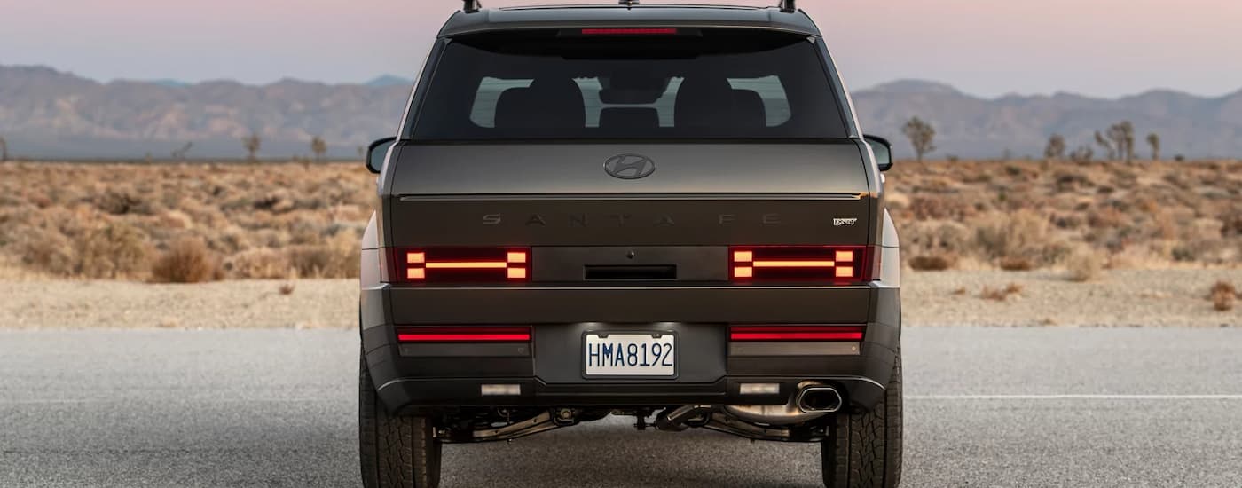 Rear view of a blue 2026 Hyundai Santa Fe parked on a road