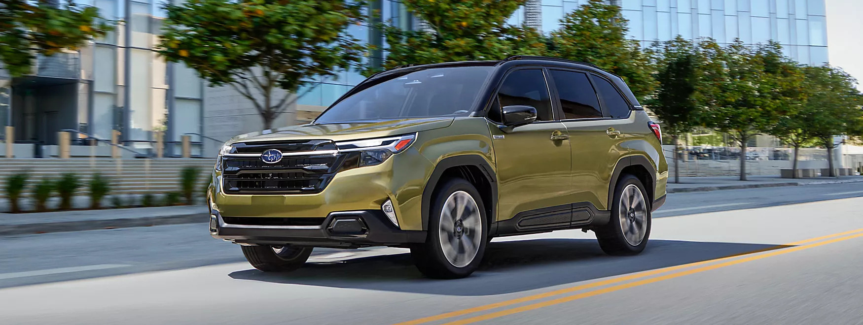 a green 2025 subaru forester driving in the city